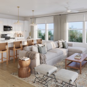 a living room with a couch, tables and chairs