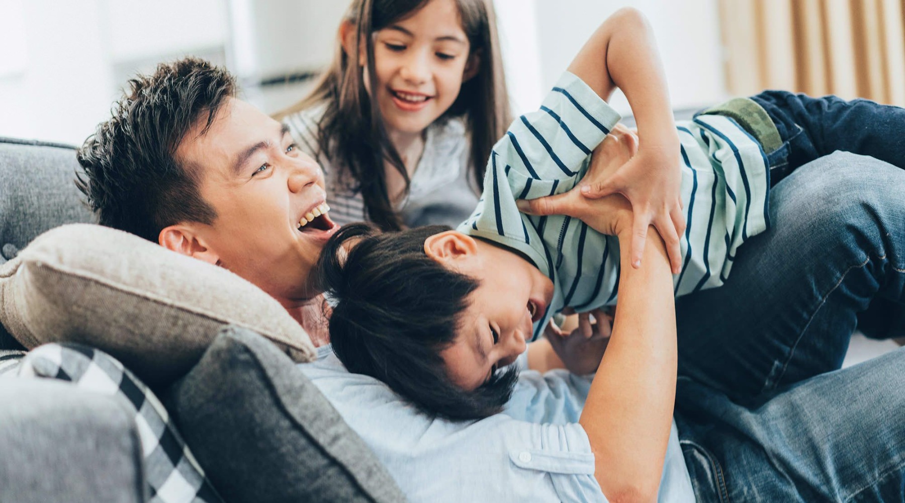 a family laughing on a couch